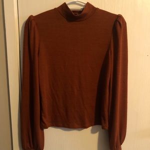 Mock neck top with shoulder puffs.